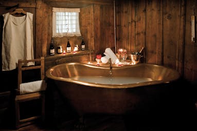 Hotel Bellevue Italy Alps spa bath brass roll top bath candlelit room 