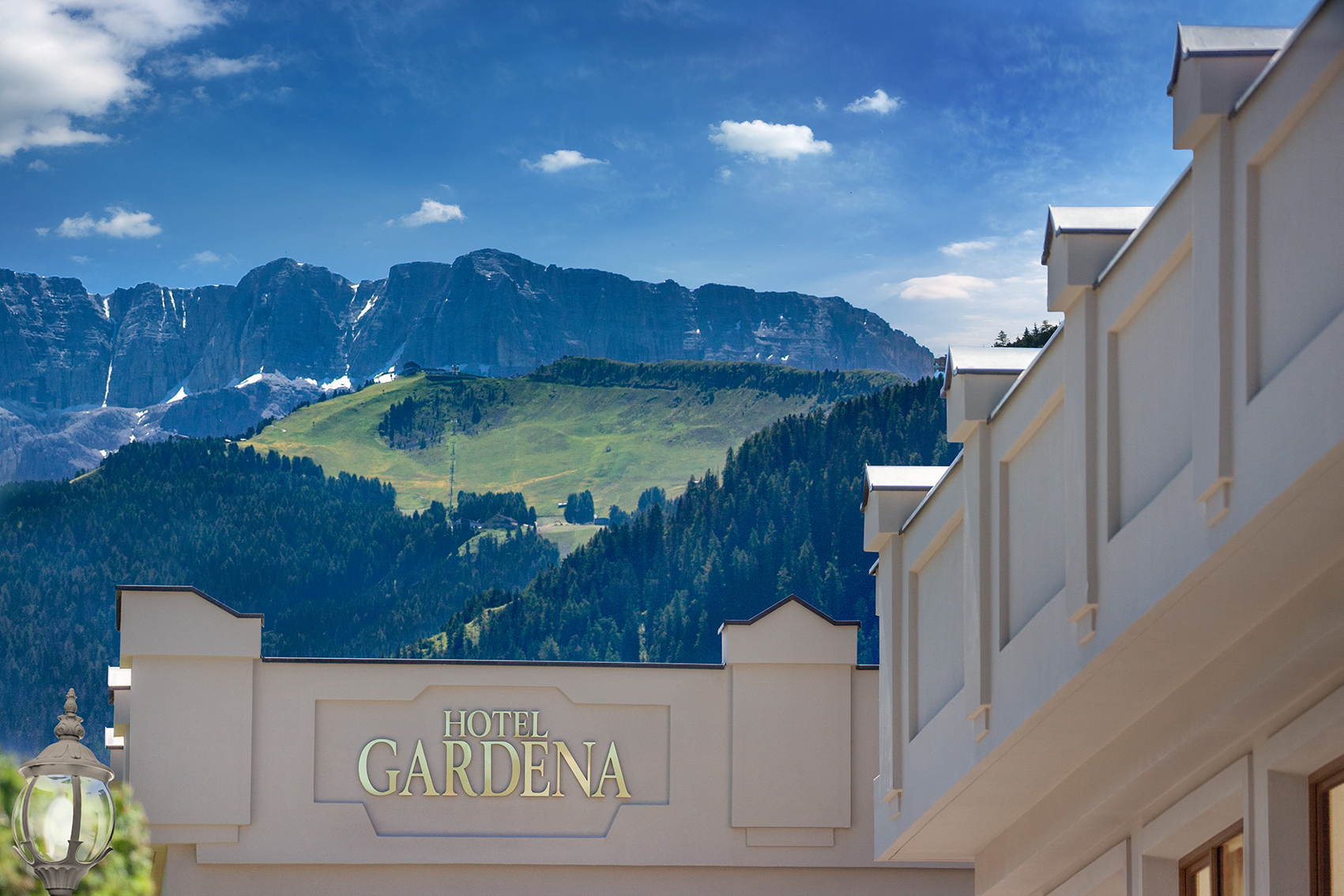 Gardena Grodnerhof entrance roof, showing the grand style and majestic green mountain scenery
