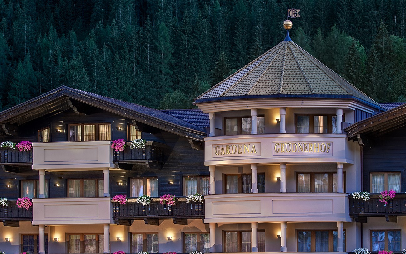 Gardena Grodnerhof exterior in the evening, showing romantically lit balconies