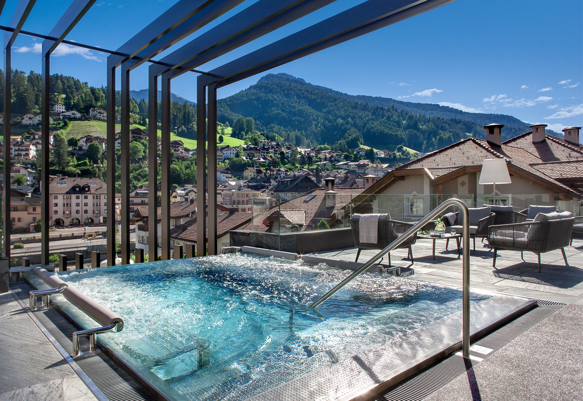 Gardena Grodnerhof rooftop pool, with jacuzzi jets and views across the surrounding village and mountains