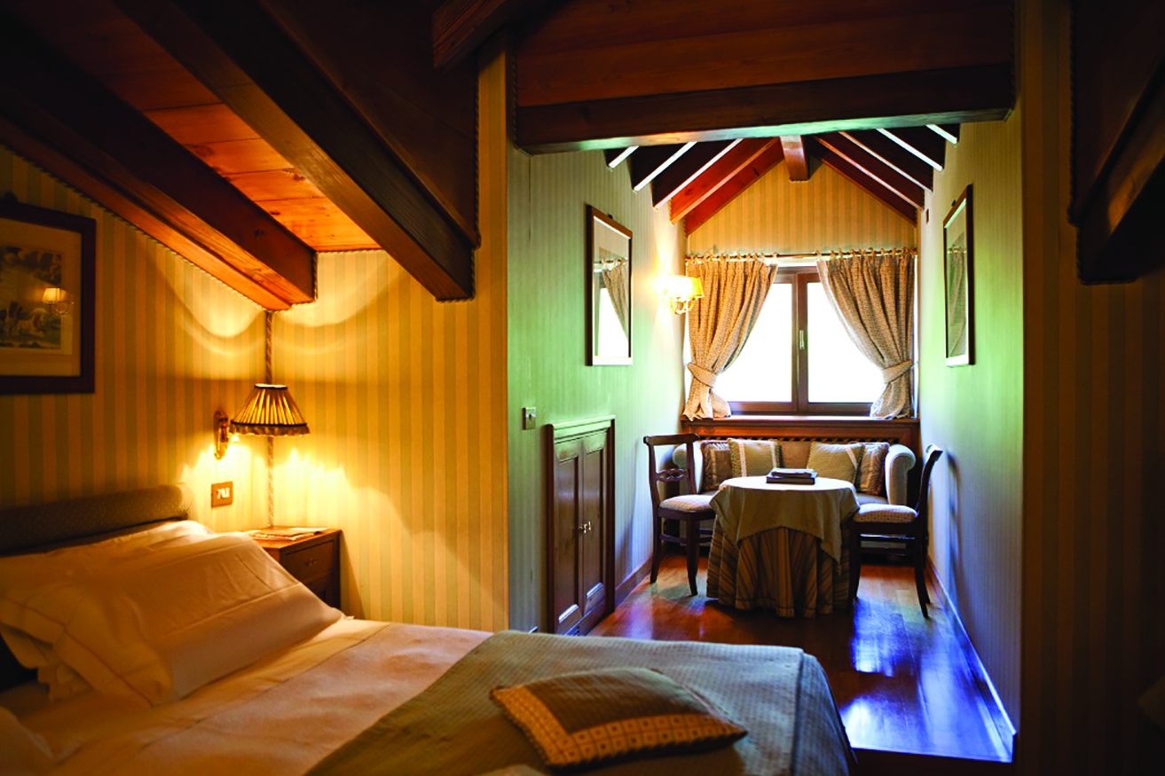 Hotel Hermitage Italy Alps classic  attic room bed seating area