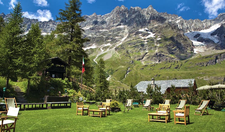 Hotel Hermitage Italy Alps gardens lawn outdoor seating mountains