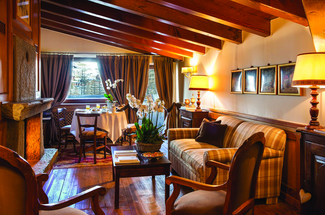 Hotel Hermitage Italy Alps  master suite lounge area dining table sofa
