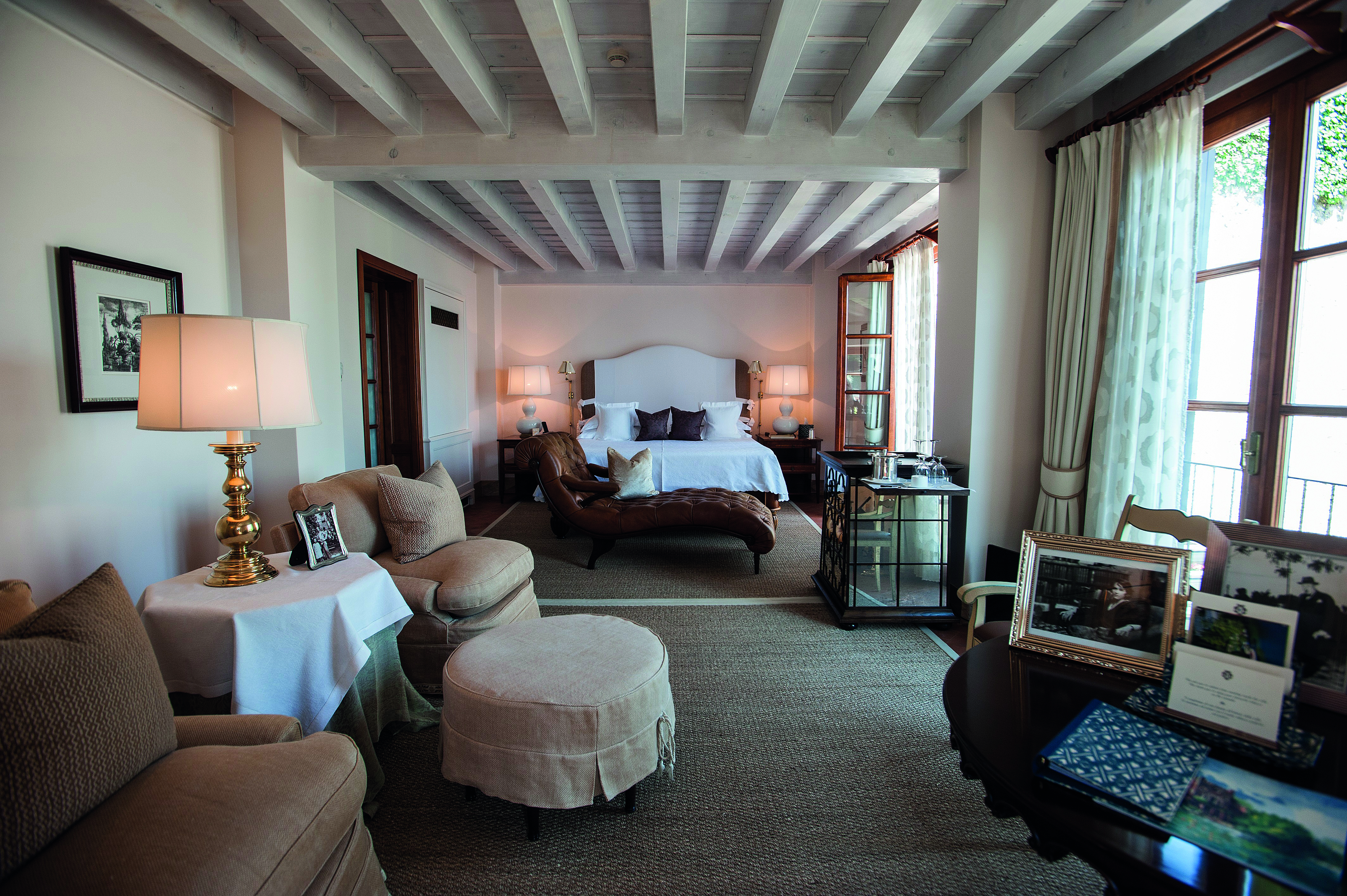 Villa Feltrinelli Lake Garda guest room bed seating area chaise longue elegant décor
