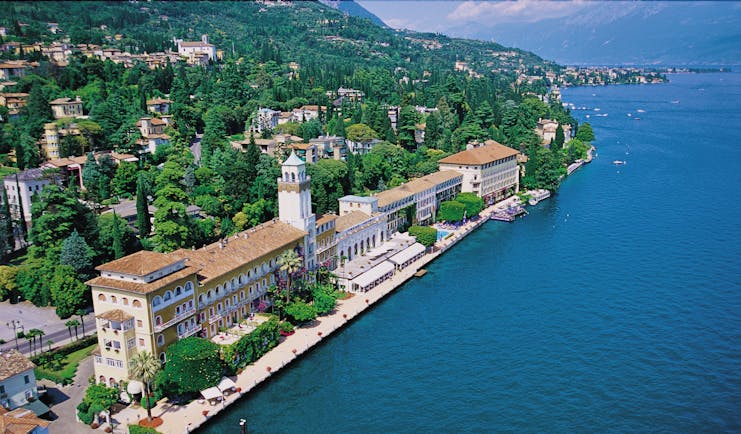 Grand Hotel Gardone birds eye view of the exterior showing the large hotel on the edge of a blue italian lake