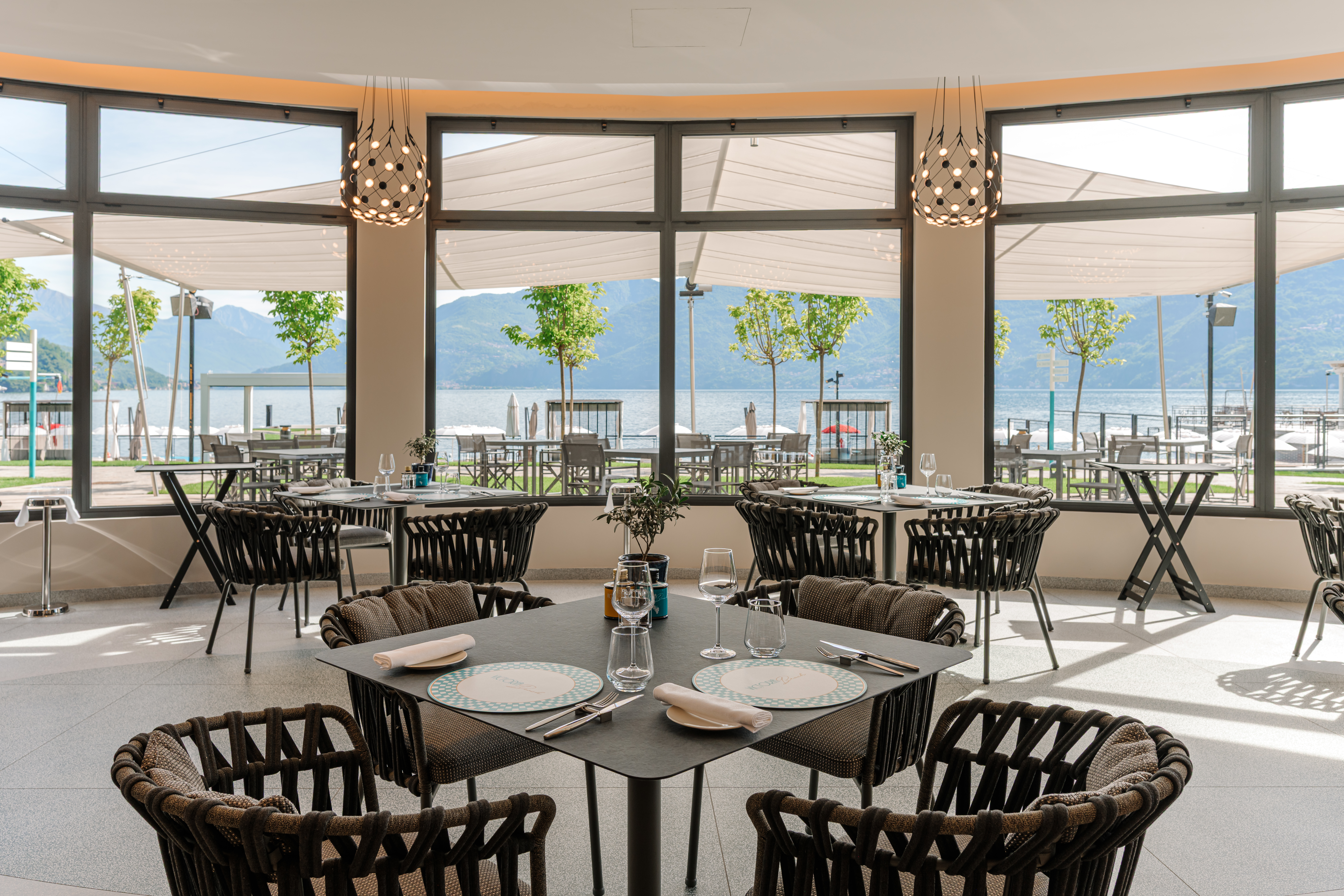 Grand Hotel Victoria Concept & Spa dining at the Victoria Beach Club, with sleek modern design and large lake view windows