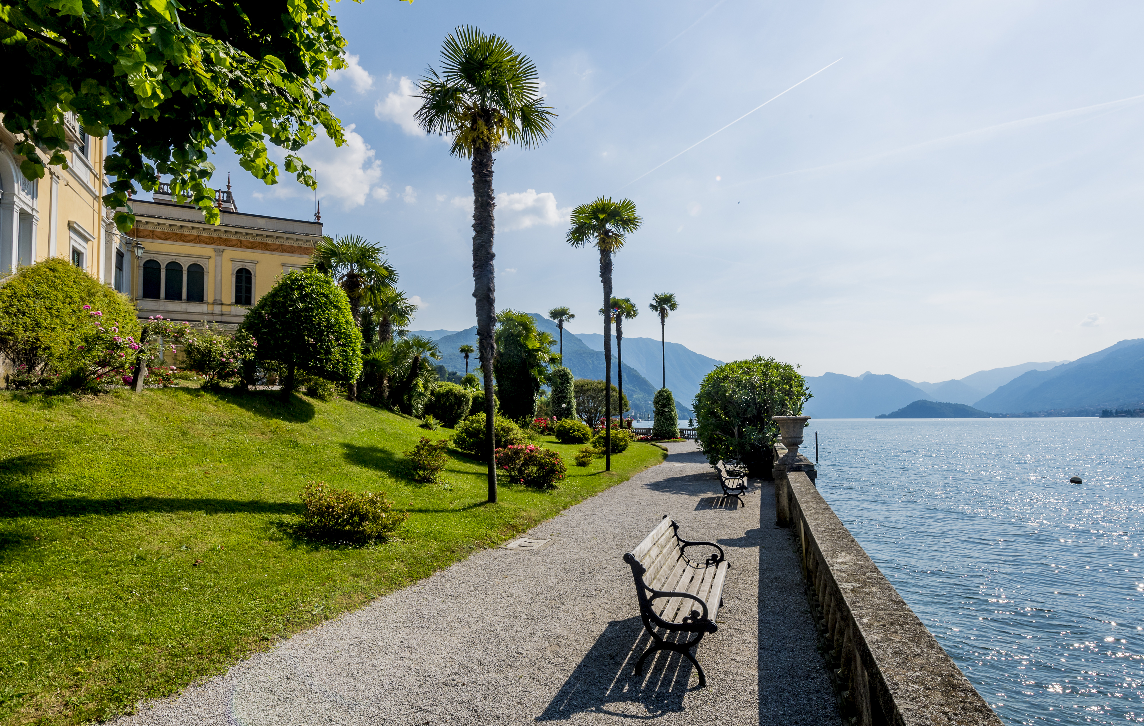 Grand Hotel Villa Serbelloni lakeside promenade with the hotel's yellow ochre building on one side and lake on the other