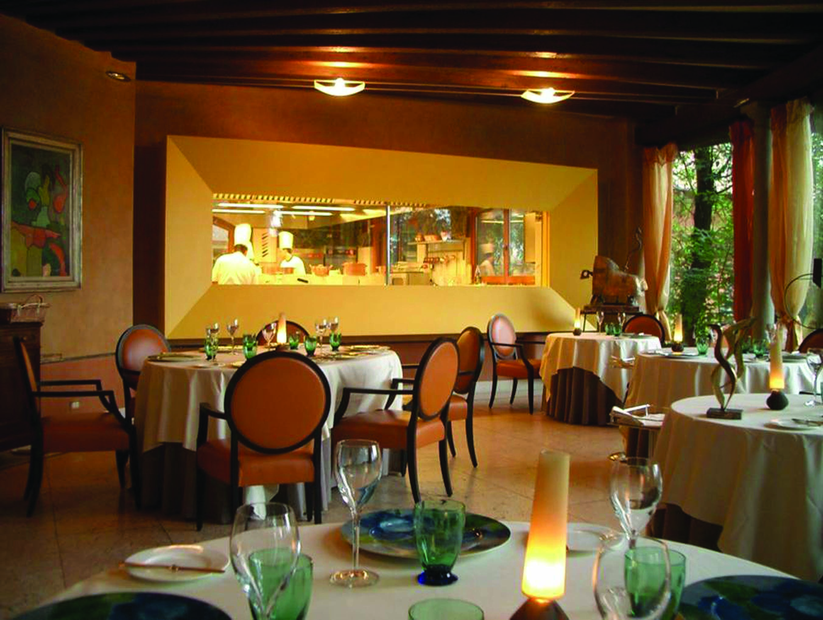 Hotel L'Albereta Lake Iseo restaurant indoor dining windows to kitchen contemporary décor