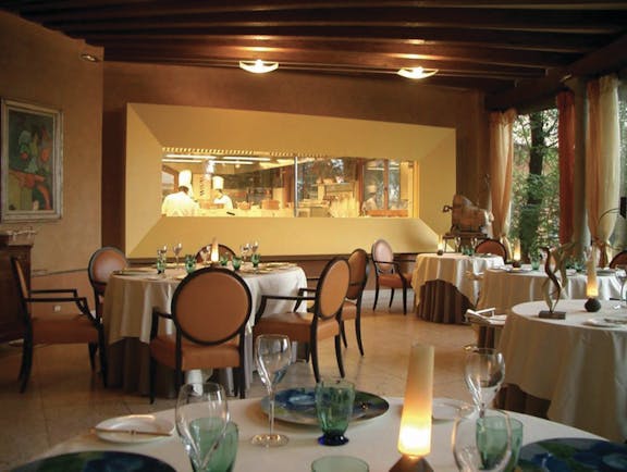 Hotel L'Albereta Lake Iseo restaurant indoor dining windows to kitchen contemporary décor