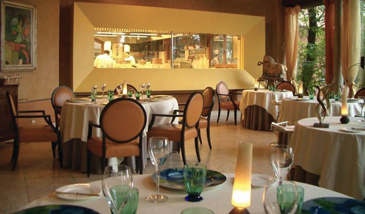 Hotel L'Albereta Lake Iseo restaurant indoor dining windows to kitchen contemporary décor