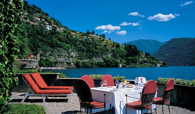 Villa d' Este Lake Como terrace sun loungers outdoor dining view of lake and surrounds