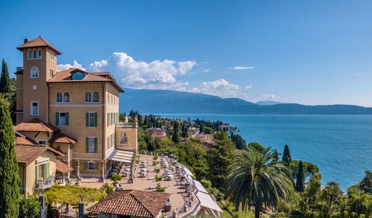 Exterior panorama with hotel building and terrace with view of the lake