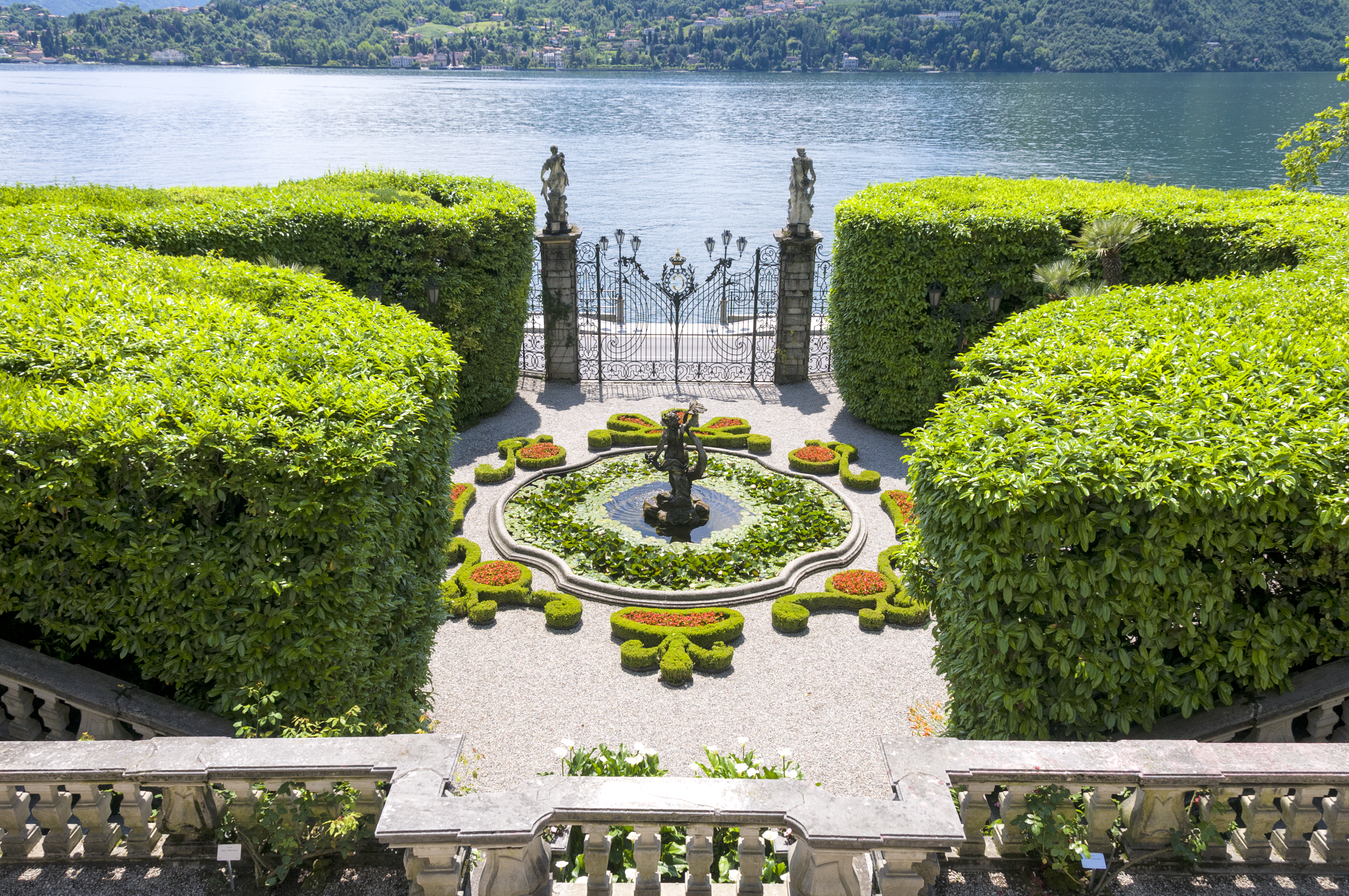 aerial view of fountain and iron gates at villa carlotta on lake como