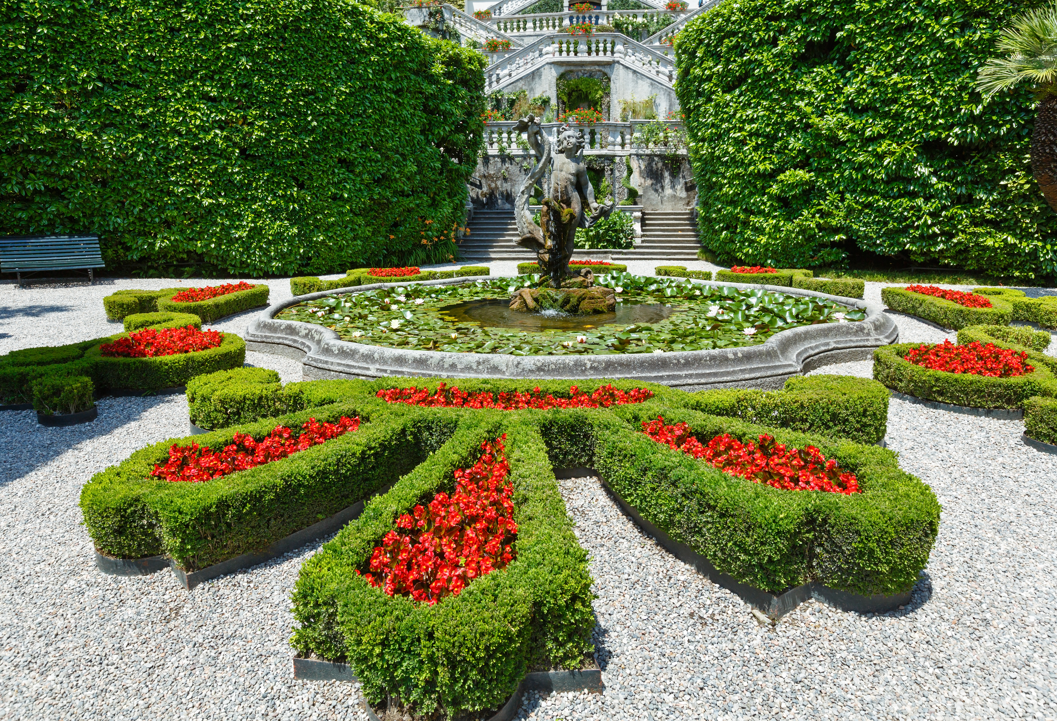 Formal flower beds of red lined with green box in parterre of villa carlotta on Lake Como