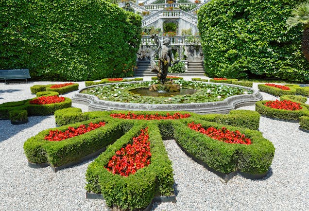 Formal flower beds of red lined with green box in parterre of villa carlotta on Lake Como