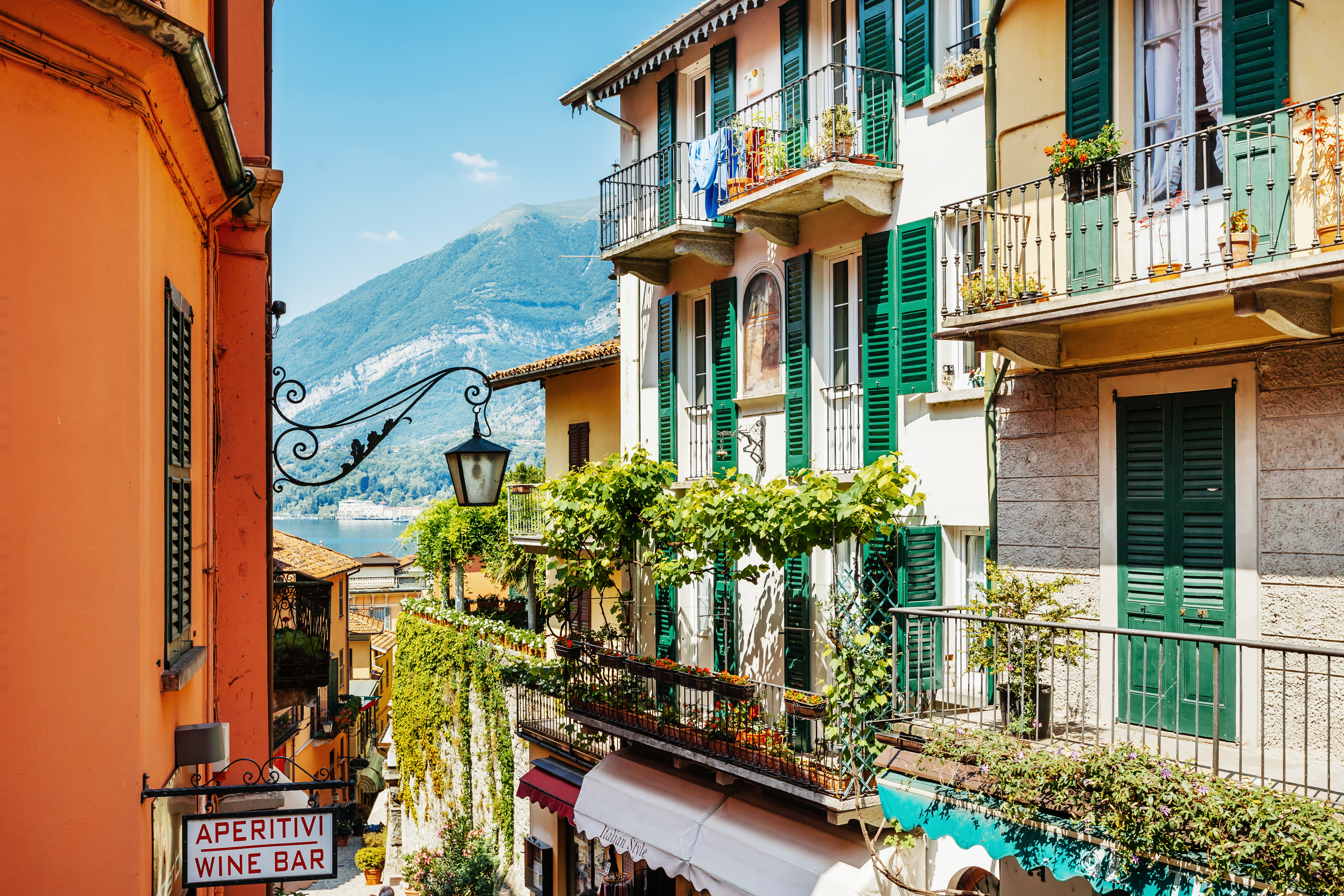 Houses with balconies and green shutters and vines overlooking Lake Como in Bellagio