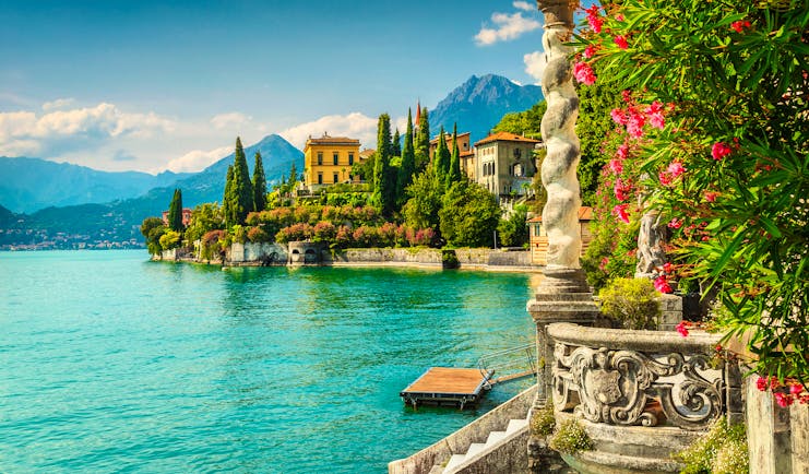 Blue waters of Lake Como with the balcony and garden frontage of the Villa Monastero