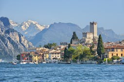 Village of Malcesine on the shore of blue Lake Garda with mountains behind