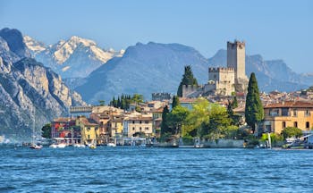 Village of Malcesine on the shore of blue Lake Garda with mountains behind