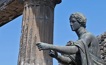 Figure of statue pointing outside roman temple Pompeii