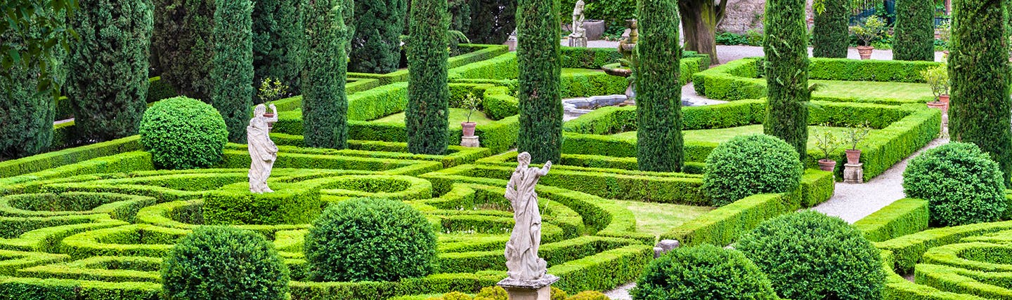 Symmettical gardens of box and cypress with statues in Verona