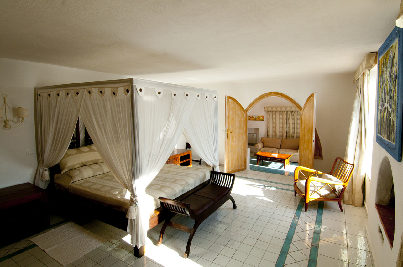 Four poster bed in large room