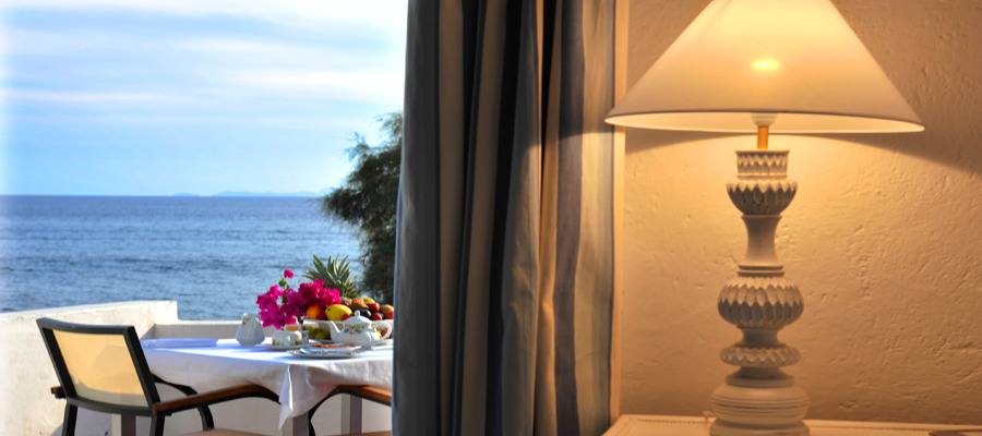 Lamp in room with balcony and sea