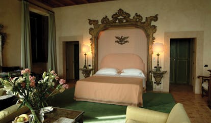 La Posta Vecchia Latium senior suite bedroom bed armchairs ornate décor