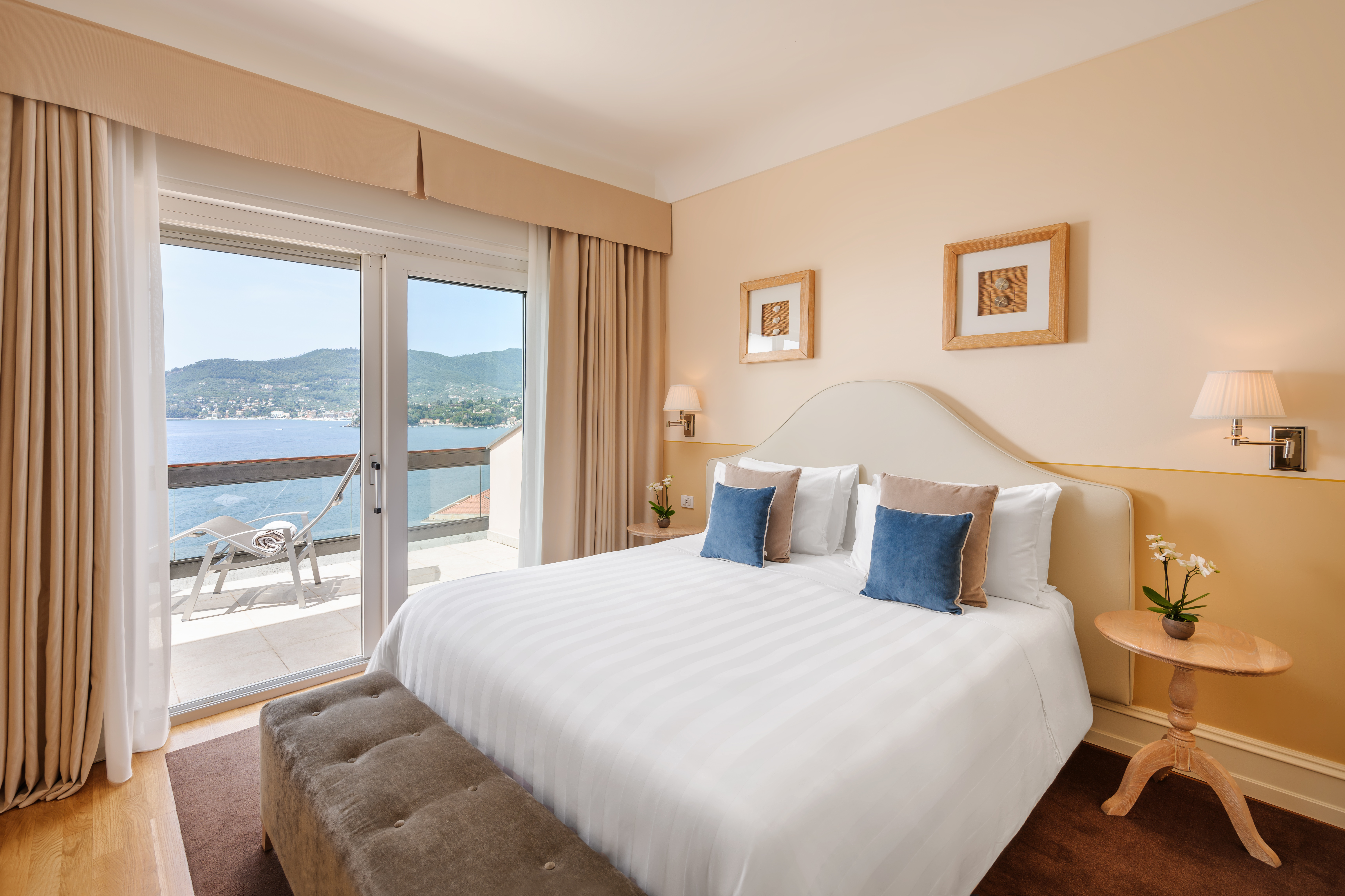 Grand Hotel Bristol Resort & Spa double room with warm, neutral tones, soft furnishings, and double doors opening onto a seaview balcony