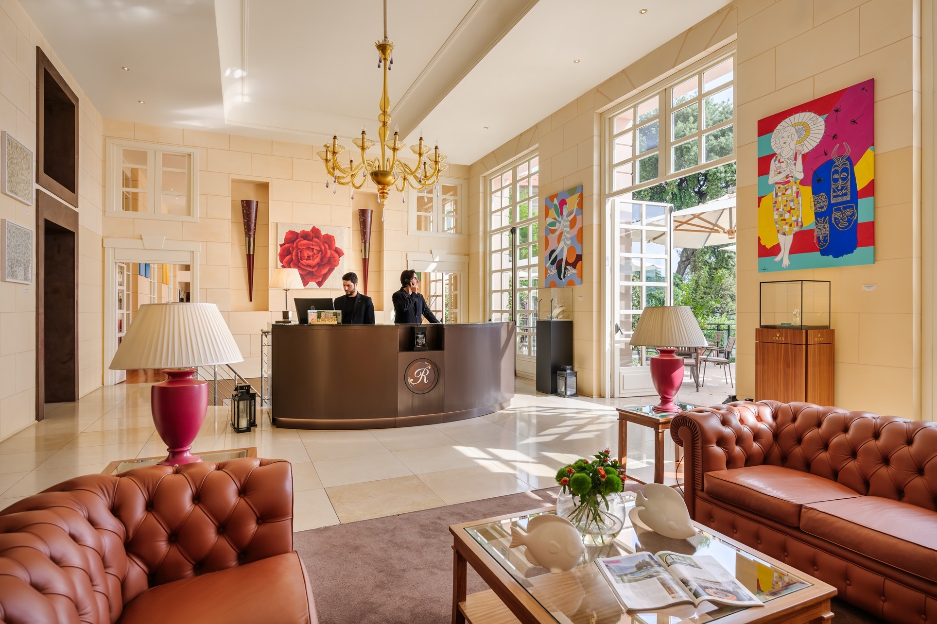 Grand Hotel Bristol Resort & Spa Lobby with leather sofas, bright pink pops of modern art, and tall windows looking out onto hotel gardens
