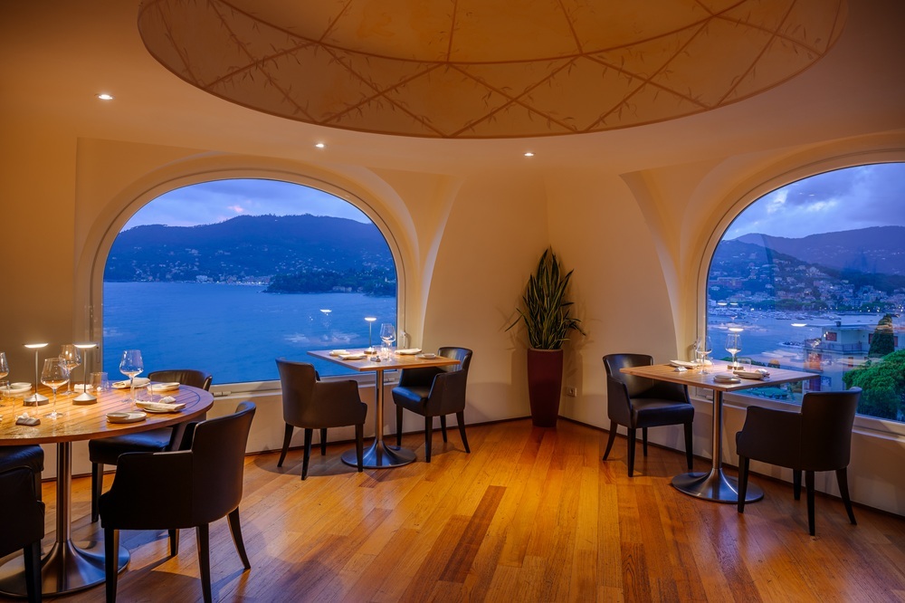 Grand Hotel Bristol Resort & Spa Le Cupole restaurant interior, with dome roof, wooden floor, and arched windows looking out across the sea