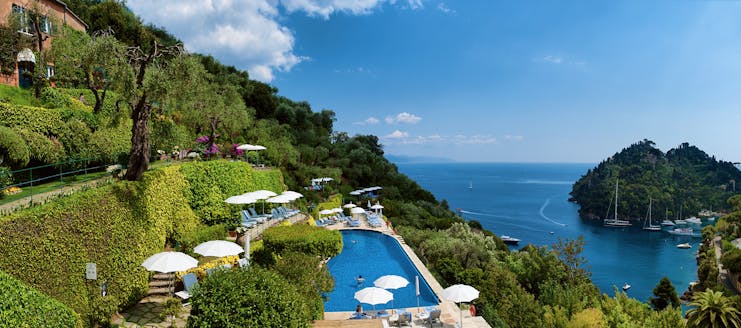 Splendido Portofino pool sun loungers umbrellas overooking the sea views of the bay