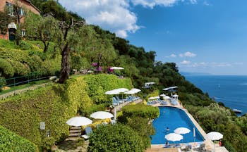 Splendido Portofino pool sun loungers umbrellas overooking the sea views of the bay