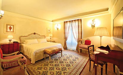 Relais Sant'Uffizio Piemonte deluxe suite bed chairs ornate décor
