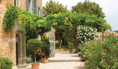 Relais Sant'Uffizio Piemonte gate hotel entrance trees flowers traditional architecture