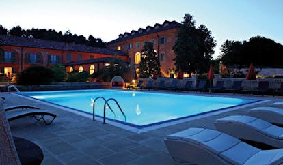 Relais Sant'Uffizio Piemonte pool at night sun loungers hotel building in background