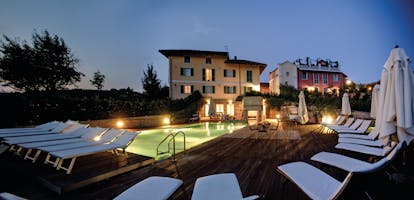 Relais Villa D' Amelia Piemonte pool lit up at night sun loungers