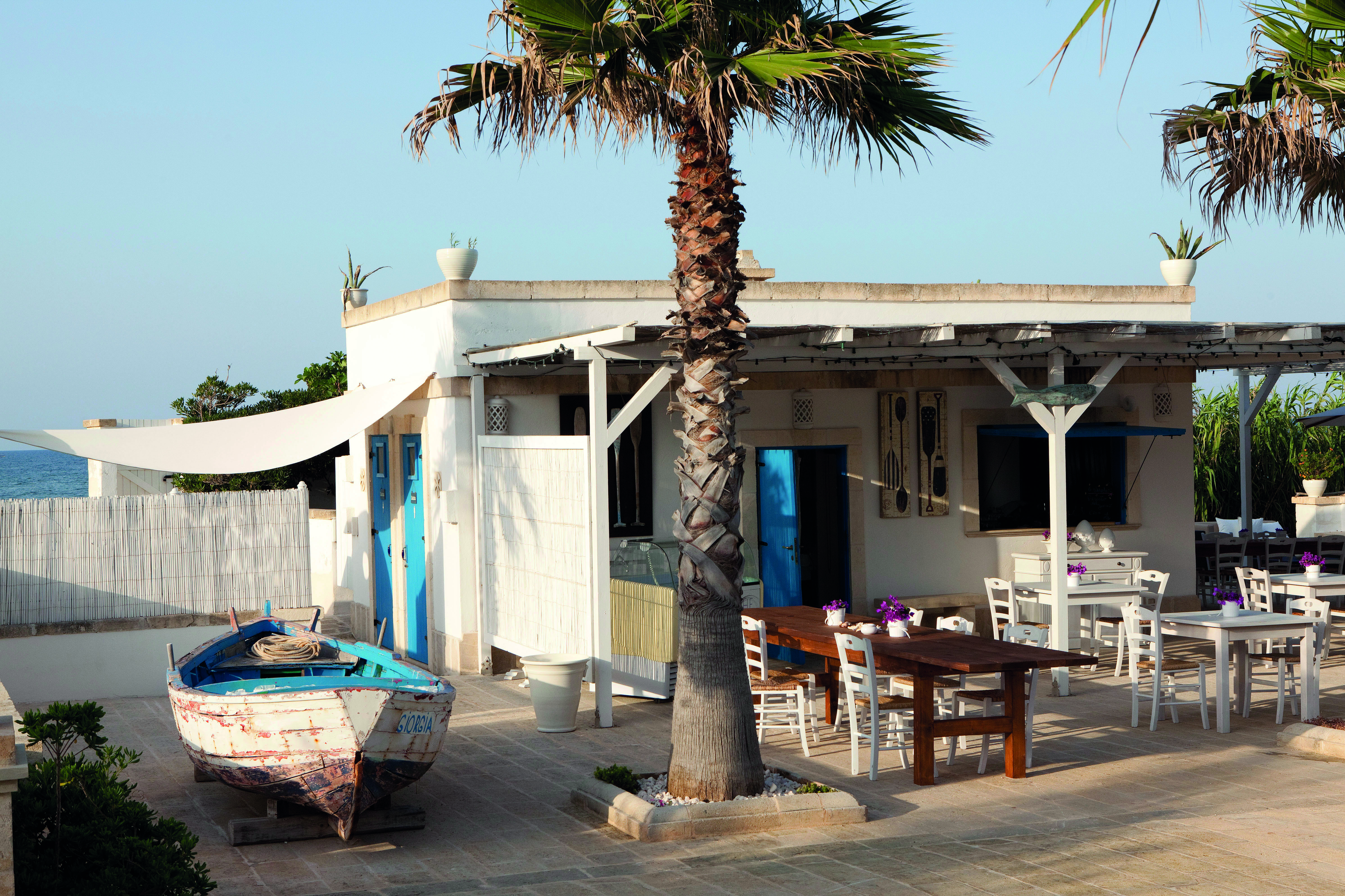 Canne Bianche Puglia dining terrace outdoor seating area and restaurant partial sea views