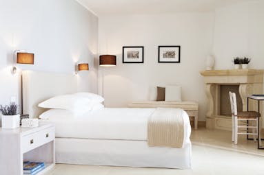 Canne Bianche Puglia junior suite bedroom modern décor bed stone corner fireplace
