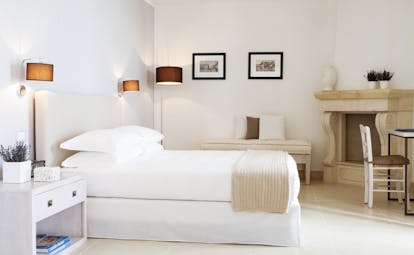 Canne Bianche Puglia junior suite bedroom modern décor bed stone corner fireplace