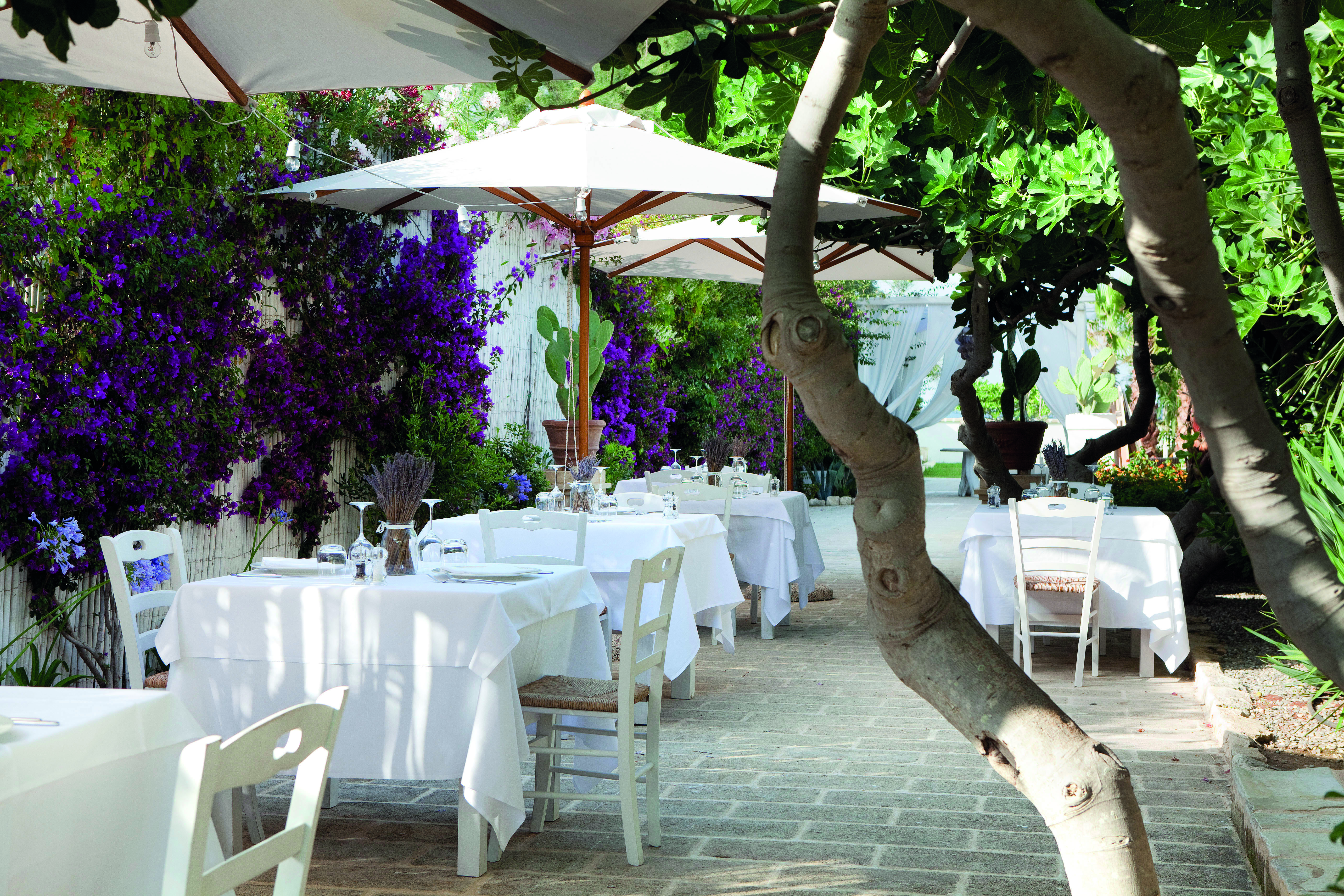 Canne Bianche Puglia outdoor restaurant seating area flowers and trees