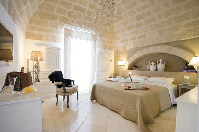 Don Ferrante Puglia deluxe room bed stone walls contemporary décor