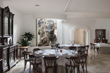 Il Melograno Puglia restaurant indoor dining window with view of tree trunk