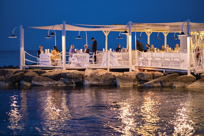 La Peschiera Puglia beach restaurant by night terrace water front dining