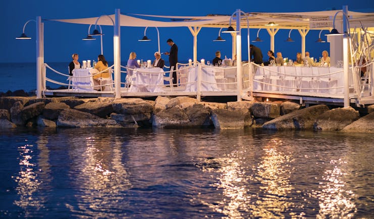 La Peschiera Puglia beach restaurant by night terrace water front dining