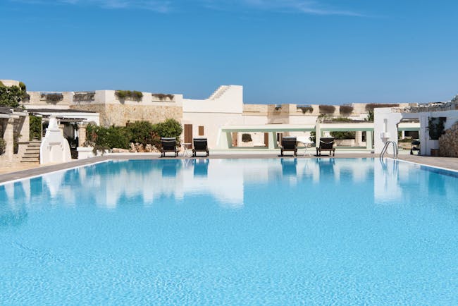 La Peschiera Puglia pool sun loungers clear blue skies