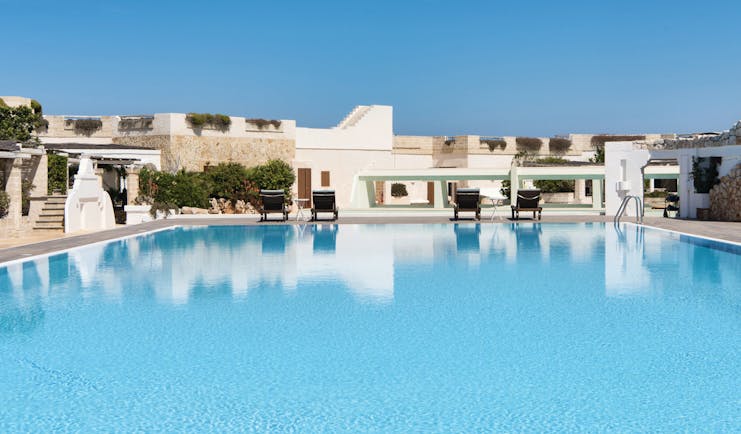 La Peschiera Puglia pool sun loungers clear blue skies
