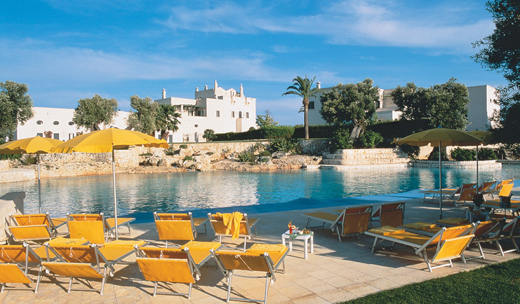Masseria San Domenico Puglia poolside sun loungers umbrellas hotel in background