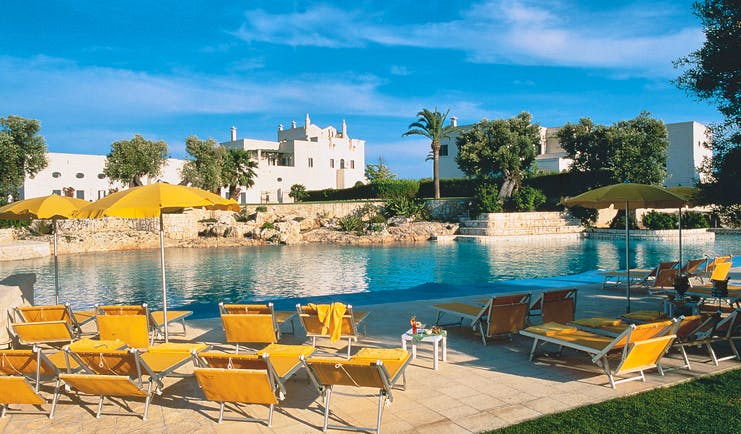 Masseria San Domenico Puglia poolside sun loungers umbrellas hotel in background