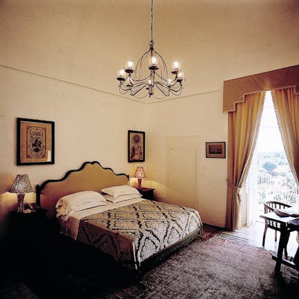 Masseria Torre Coccaro Puglia deluxe junior suite bed balcony traditional décor